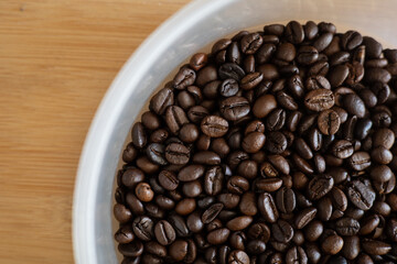 Coffee beans placed in a plastic box, close-up photo