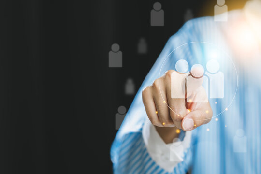 A person pointing towards digital user icons, symbolizing connection and engagement in a professional context.