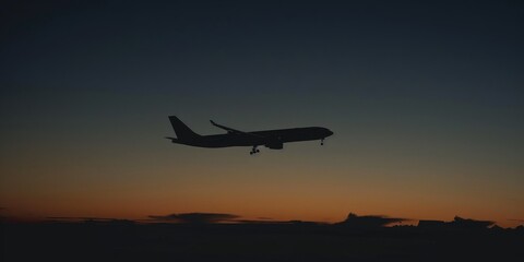 Shadowed silhouette of a commercial airliner flying at dusk.
