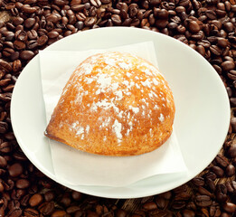 Delicious sfogliatella frolla lying on plate with coffee beans