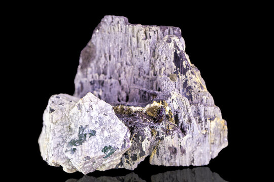 Mineral wolframite on a black background. Tungsten ore, iron tungstate and manganese