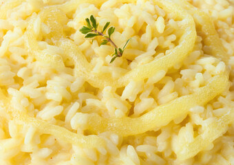 Saffron risotto with melted cheese and thyme garnish