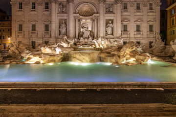 The Trevi Fountain, one in the morning at blue hour. No people but well lit. Monumental fountain in...