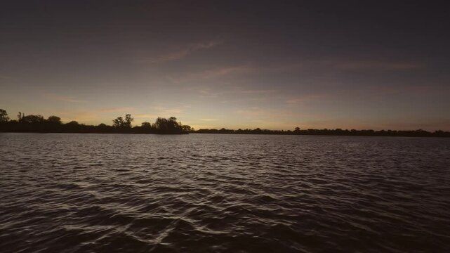 Filming of the Tejo  River in Portugal with sunset and trees.