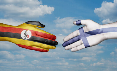 Finland and Uganda country handshaking with flags, consensus concept international co-operation illustration