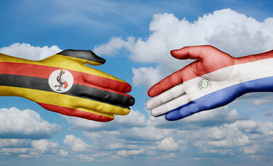 Paraguay and Uganda country handshaking with flags, consensus concept international co-operation illustration