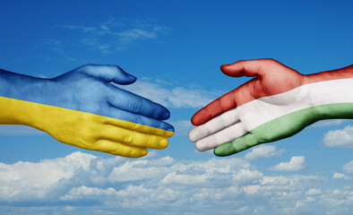 Hungary and Ukraine country handshaking with flags, consensus concept international co-operation illustration