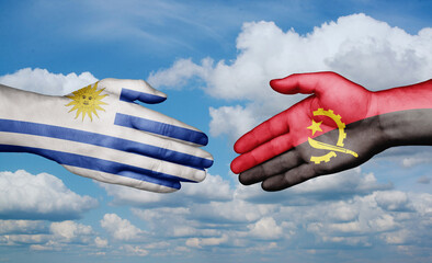 Uruguay and Angola country handshaking with flags, consensus concept international co-operation illustration