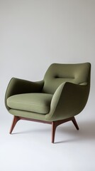 Modern green armchair standing on white background