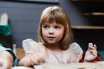 Fototapeta premium Girl engaged in creative activity at an art studio during the day