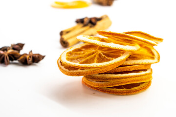 Cut orange and different spices  on white background. Traditional festive winter beverage.Cinnamon, dried orange, anise and cloves