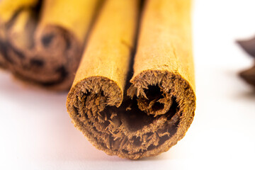 Cut orange and different spices  on white background. Traditional festive winter beverage.Cinnamon, dried orange, anise and cloves