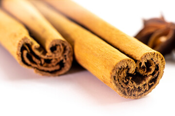 Cut orange and different spices  on white background. Traditional festive winter beverage.Cinnamon, dried orange, anise and cloves