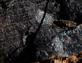 Lava formations, stones, black basalt in the rocks closeup on a volcano terrain.
