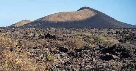 Landsape with volcanoes, mountains and volcanic rocky terrain.
