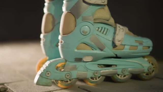Close-up side shot of rollerblades gently rolling in place against a nighttime background. the motion and texture of the skates, emphasizing the urban, nocturnal ambiance and active lifestyle