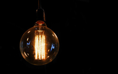 Vintage style light bulbs hanging on ceiling. Decorative lights. Old Edison bulb, electrical...