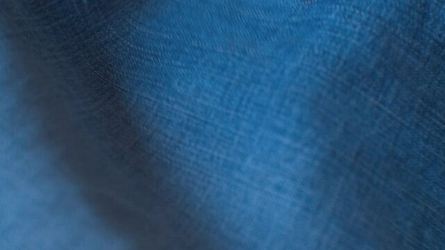 Beautiful vintage blue denim fabric. Moving background. Close-up