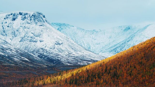 Valley with autumn mountains covered with first snow