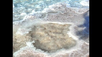 Salt deposits turn into organic sculptures, shaped by coastal tides. Mineral formations enhance coastal beauty, adding texture to waters edge in peaceful and natural setting. Salt Crystals by Water