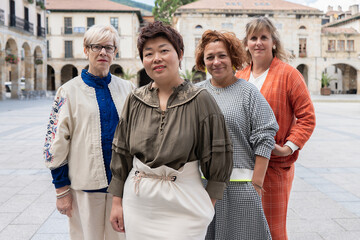 Diverse group of women posing together in a square