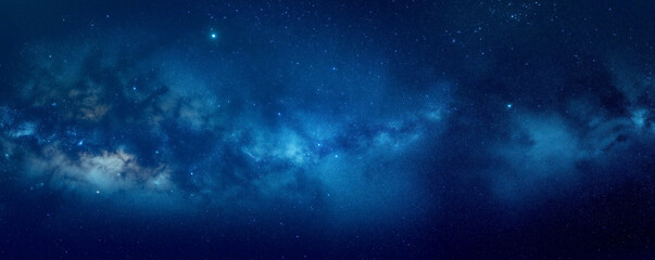 A dark blue background with stars, galaxies, and space dust. Viewing the universe in an abstract manner.