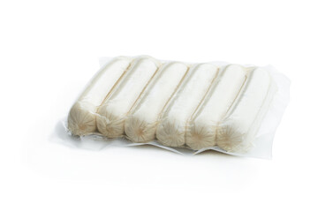 Raw thin chicken sausages in a vacuum package isolated on white