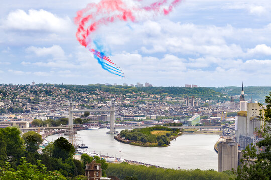 ROUEN, NORMANDY, FRANCE: aerial view of "Patrouille de France",  French Acrobatic Patrol, performing aerobatic figures above the city of Rouen with and Gustave Flaubert bridge lifted