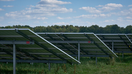 Obraz premium Large solar energy farm wit photovoltaic panels in rows seen from behind, Drenthe, Netherlands