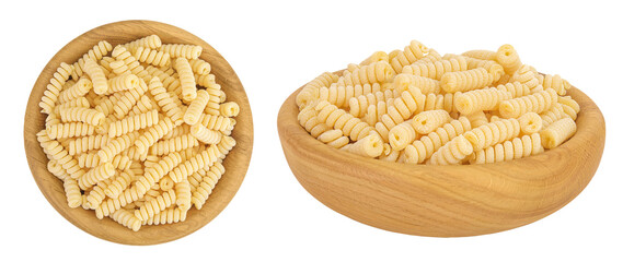 Italian spiral shaped pasta, Fusilli bucati macaroni in wooden bowl, isolated on white background. Top view. Flat lay.