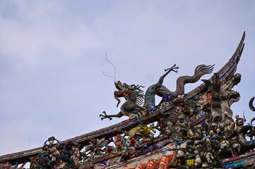 Close-up of the ornate decor on the Mengjia Longshan Temple in Taipei, Taiwan. Chinese folk religion landmark. Buddhist Temple. Religious and traditional Chinese art. 
