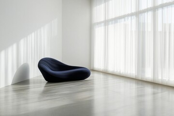 An all-white room with a polished concrete floor and a single, navy-blue sofa inside the room, window with sheer curtains. 