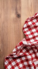 Red and white checkered tablecloth on a wooden background