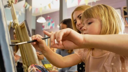 Children and adults explore creativity together at a colorful art workshop