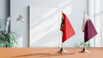 FLAGS OF EAST TIMOR AND QATAR ON TABLE