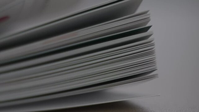 Reading or education concept. Flicking through old book pages. Turning the pages of an old book close-up.Pages turning. Scrolling a Book in Macro. Macro shot of flipping white pages.