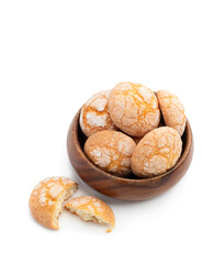 Homemade mini sugar cookies in wooden bowl isolated on white