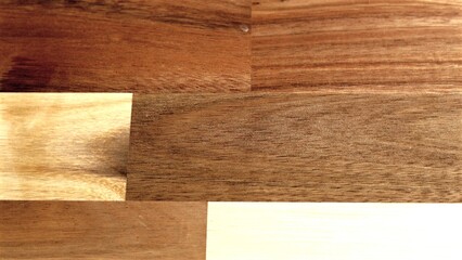 Richly textured wooden surface displaying contrasting light and dark grains blended together. Smooth finish highlights depth within natural wood variations creating visual interest.