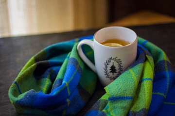Cup of hot tea with lemon and coffin scarf.