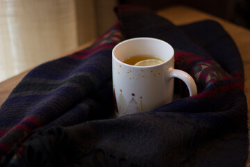 Cup of hot tea with lemon and coffin scarf.
