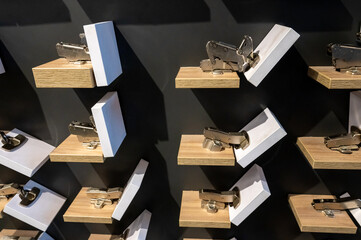 Display of Modern Kitchen Cabinet Hinges on Shelves
