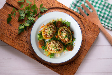 Baked potatoes stuffed with meat and baked in the oven. Top view table with  decorations.