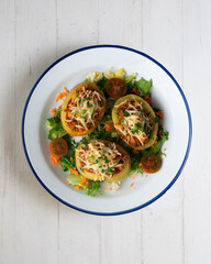 Baked potatoes stuffed with meat and baked in the oven. Top view table with  decorations.