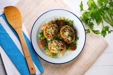 Baked potatoes stuffed with meat and baked in the oven. Top view table with  decorations.