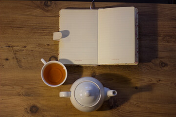 Autumn evening with tea, cookie and notebook.