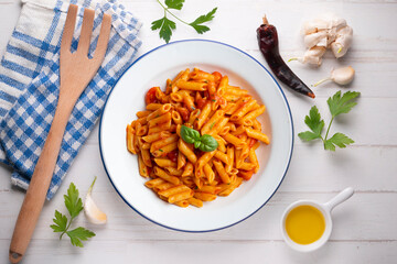 Macaroni with tomato and basil aroma. Top view table with  decorations.