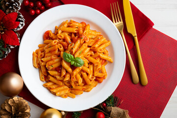 Macaroni with tomato and basil aroma. Top view table with Christmas decorations.