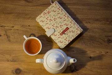 Autumn evening with tea, cookie and notebook.