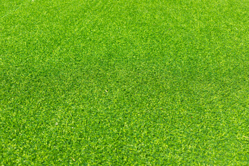 Close-up of lush green artificial grass, showcasing its detailed texture and vibrant color, perfect for outdoor landscaping and sports fields.