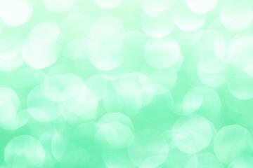 Close-up of sparkling green glitter texture creating a vibrant and festive background with shimmering lights and reflective surfaces, perfect for celebrations and decorative projects.